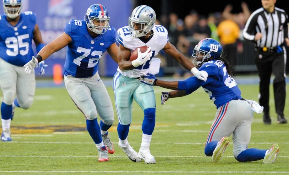 Dallas Cowboys Joseph Randle breacks a tackle by New York Giants Brandon Meriweather during the first half of an NFL football game Sunday Oct. 25 2015 in East Rutherford N.J