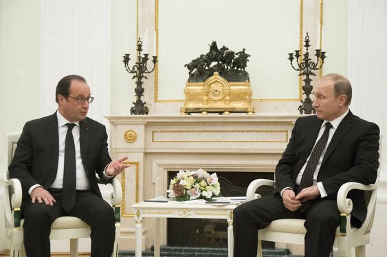 Putin right listens to France's President Francois Hollande during their meeting in Moscow Russia Thursday Nov. 26 2015