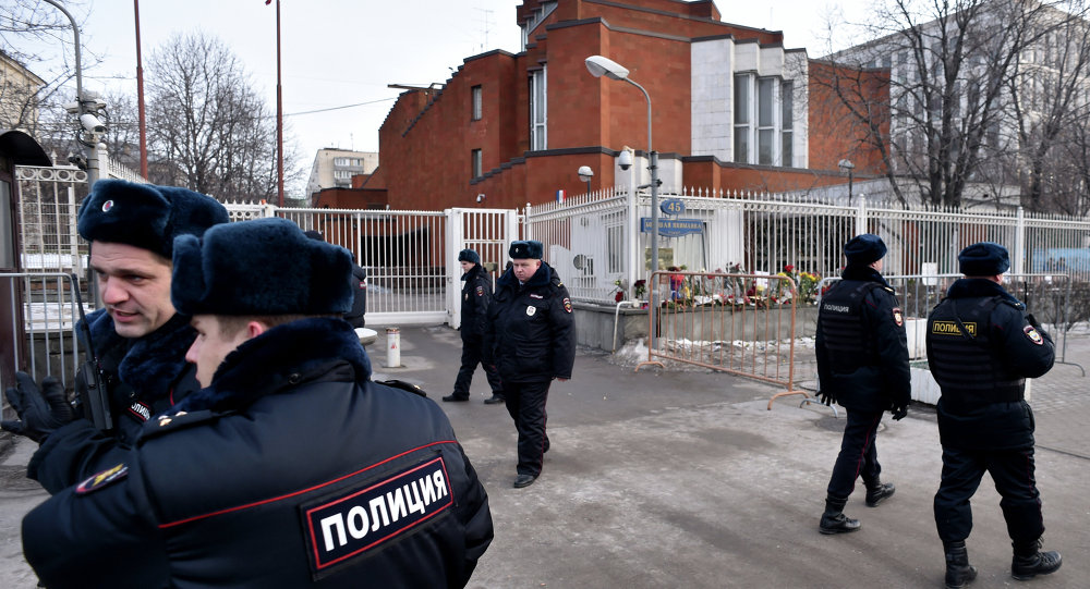 Russian police officers patrol next to the French embassy in Moscow