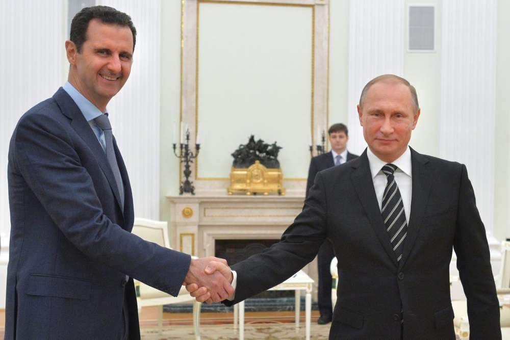 Russian President Vladimir Putin right shakes hand with Syria President Bashar Assad in the Kremlin Tuesday Oct. 20 2015