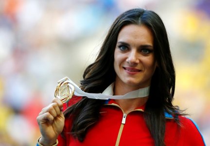 Gold medallist Yelena Isinbayeva of Russia holds her medal at the women's pole vault victory ceremony during the IAAF World Athletics Championships at the Luzhniki stadium in Moscow