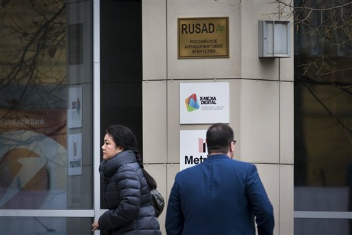 People walk at the building where Russia's anti-doping agency RUSADA in Moscow Friday Nov. 13 2015. In an effort to avoid a ban from track and field Russia offered broad cooperation on doping reforms on Friday including the creation of