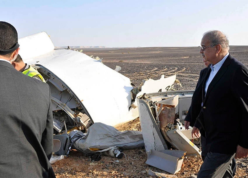 Sherif Ismail right looks at the remains of the crashed passenger jet in Hassana