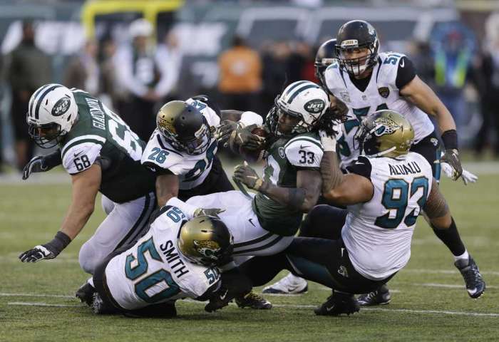 Jets running back Chris Ivory is brought down by Jaguars defenders Telvin Smith, Josh Evans and Tyson Alualu during the fourth quarter of Sunday game in East Rutherford N.J. AP