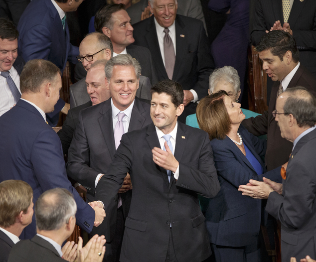 Newly-elected House Speaker Paul Ryan R-Wisc. is escorted to the House chamber following the resignation of John Boehner at the Capitol in Washington Thu