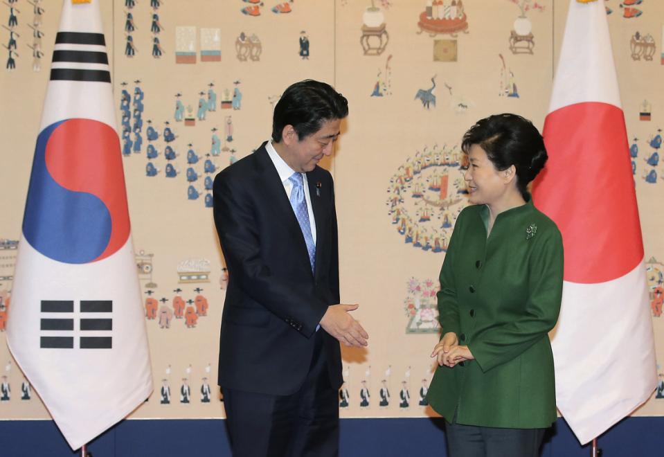 Japanese Prime Minister Shinzo Abe left offers his hand to shake hands with South Korean President Park Geun-hye before their meeting at the presidential Blue House in Seoul South Korea Monday Nov. 2 2015. /Yonhap via AP  Lee Jung-hun