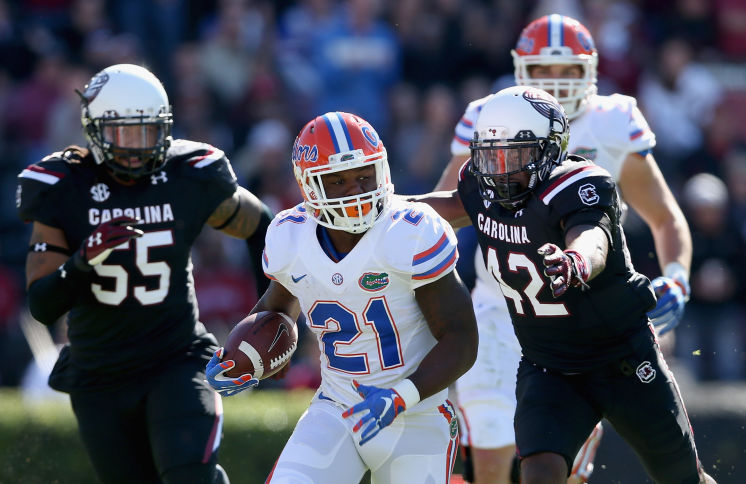 Jordan Diggs #42 of the South Carolina Gamecocks dives after Kelvin Taylor #21 of the Florida Gators during their game at Williams Brice Stadium