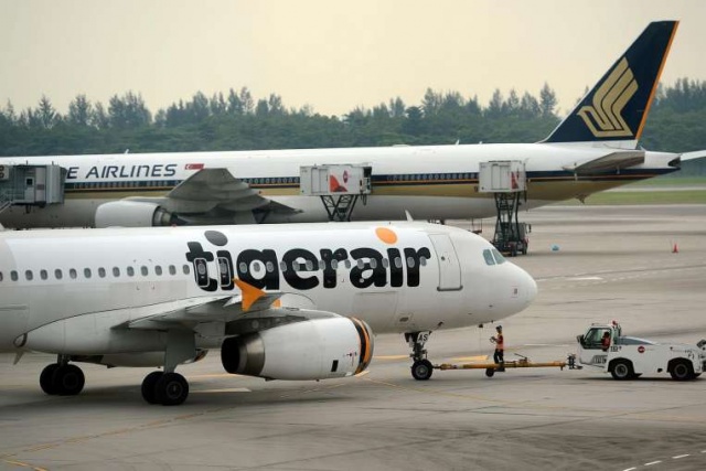 A Tigerair and SIA plane at Changi Airport in 2013