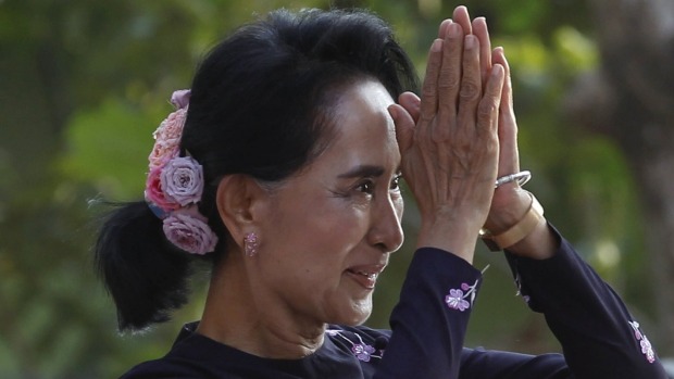 Myanmar pro-democracy leader Aung San Suu Kyi greets supporters at a campaign rally