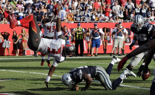 Tampa Bay Buccaneers quarterback Jameis Winston flies through the air after fumbling the football against the Dallas Cowboys during the fourth quarter of an NFL football game Sunday Nov. 15 2015 in Tampa Fla. Dallas was called for holding helping