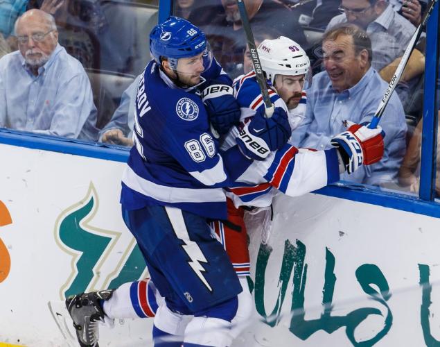 Tampa Bay's Nikita Kucherov sends Keith Yandle crashing into the boards