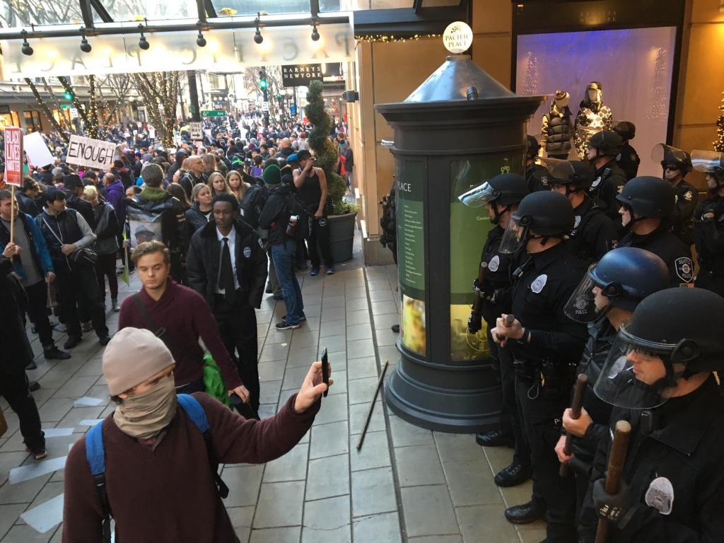 Seattle Police keep Black Lives Matter protesters away from an entrance to Pacific Place shopping center