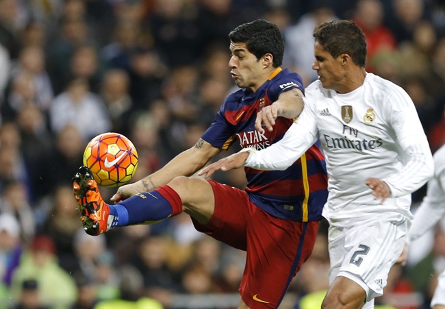 Barcelona's Luis Suarez fights for the ball with Real Madrid's Raphael Varane during the first clasico of the season between Real Madrid and Barcelona at the Santiago Bernabeu stadium in Madrid Spain Saturday Nov. 21 2015