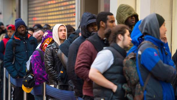 Shoppers queue outside a branch of Foot Locker on Oxford Street London as many retailers offer one day sales for Black Friday