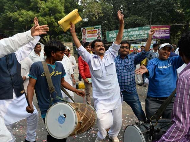 Indian Janta Dal United activists and supporters celebrate after a victory by an alliance led by their party in New Delhi