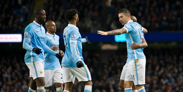 Manchester City's Aleksandar Kolarov right celebrates with teammates after scoring during the English Premier League soccer match between Manchester City and Southampton