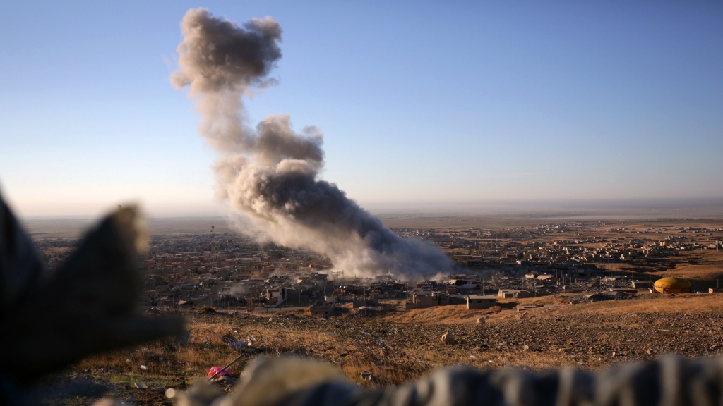 Smoke believed to be from an airstrike billows over the northern Iraqi town of Sinjar on Thursday