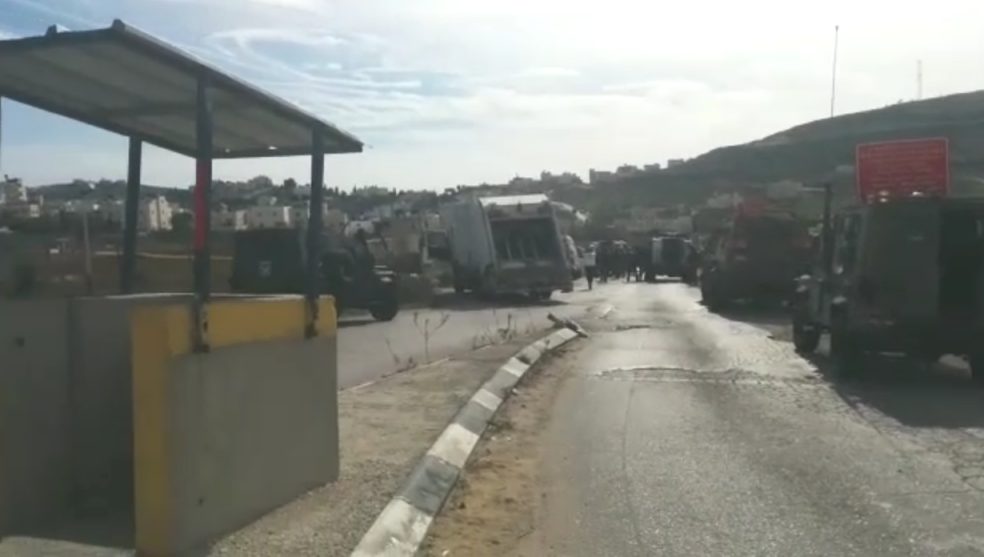 Soldiers and paramedics arrive on the scene of a stabbing outside of Hebron