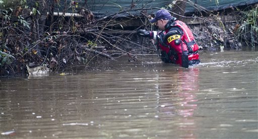 Carl Hall of Horry County Fire and Rescue searches a creek for a 5-month-old girl believed to be lost in Socastee Swamp waters Wednesday Nov. 4 2015 after the mother said Tuesday she'd put the baby in brown swirling waters. The mother Sarah Lane Tone