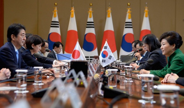 South Korean President Park Geun-Hye right talks with Japanese Prime Minister Shinzo Abe during their meeting