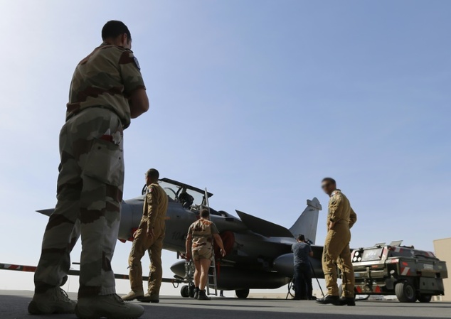 French soldiers prepare a Rafale fighter jet at a military base at an undisclosed location in the Gulf