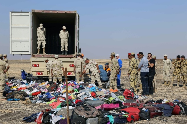 2 2015 by Russia's Emergency Ministry shows Russian emergency services personnel and Egyptian servicemen working at the crash