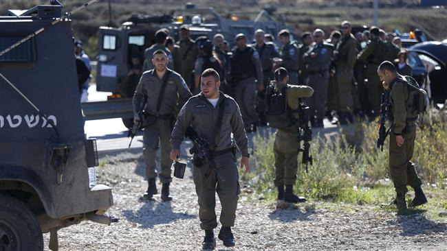 Israeli forces gather at the scene where a Palestinian man was shot after reportedly ramming a car into Israeli troops at the Tapuah junction south of Nablus in the occupied West Bank