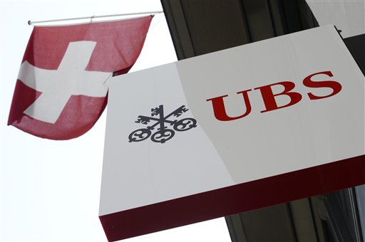 Swiss bank UBS and the Swiss flag in Zurich Switzerland. UBS has reported a 71 percent increase in third quarter profit Tuesday Nov. 3 2015 as the banking giant took a big tax benefit while pred