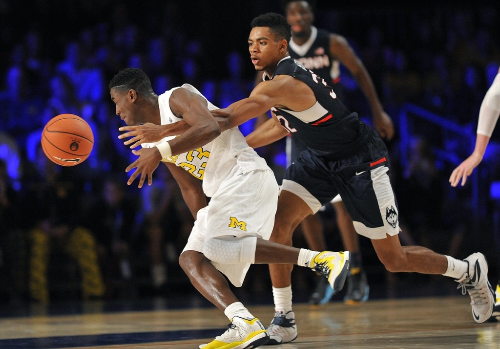 Connecticut forward Shonn Miller pokes the ball away from Michigan guard Caris Le Vert Wednesday Nov. 25 2015 in Paradise Island Bahamas