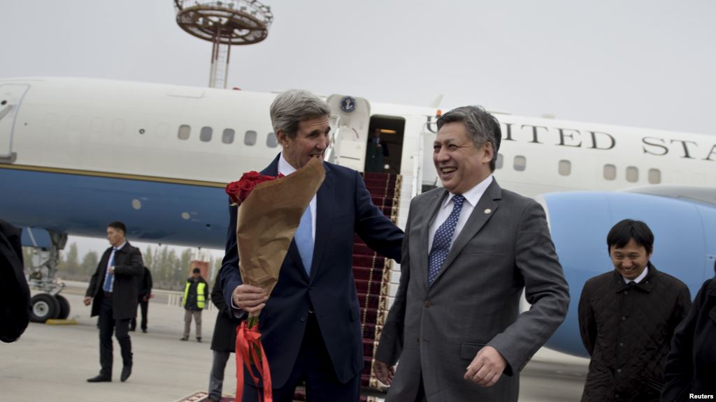 U.S. Secretary of State John Kerry shares a laugh with Kyrgyz Foreign Minister Erlan Abdyldaev upon his arrival at Manas International Airport in Bishkek Oct. 31 2015