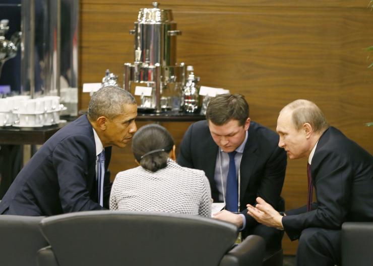 U.S. President Barack Obama talks with Russian President Vladimir Putin