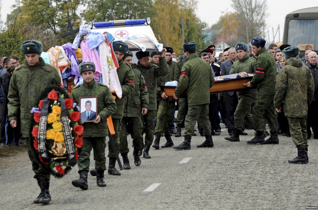 Russian servicemen carry the coffin of Vadim Kostenko one of the Russian air force's support staff in Syria during his funeral in the village of Grechnaya Balka north-west of Krasnodar Russia Oct. 28 2015