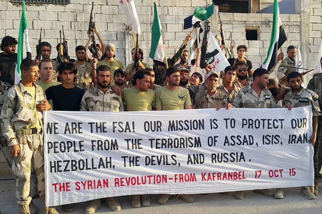 17 2015 and provided by the Fursan al Haq Syrian rebel brigade which has been authenticated based on its contents and other AP reporting Free Syrian Army fighters of Fursan al Haq Brigade hold a banner in Kafranbel