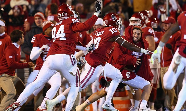 NORMAN OK- NOVEMBER 21 Matt Dimon #94 Steven Parker #10 and Baker Mayfield #6 of the Oklahoma Sooners celebrate a failed two-point conversion by the TCU Horned Frogs in the fourth quarter at Gaylord Family Oklahoma Memorial Stadium