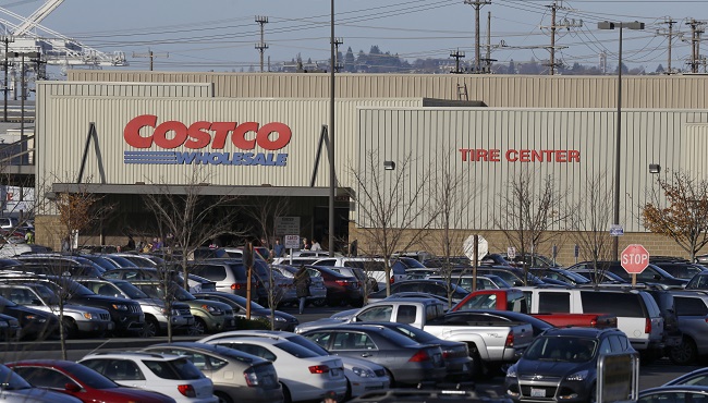 Cars fill the parking lot of a Costco store Tuesday Nov. 24 2015 in Seattle. Health authorities say chicken salad from Costco has been linked to at least one case of E. coli in Washington state