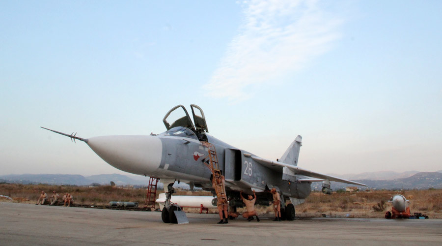 Technicians service a Russian Sukhoi Su-24 Fencer tactical bomber at Syria's Hmeimim airport