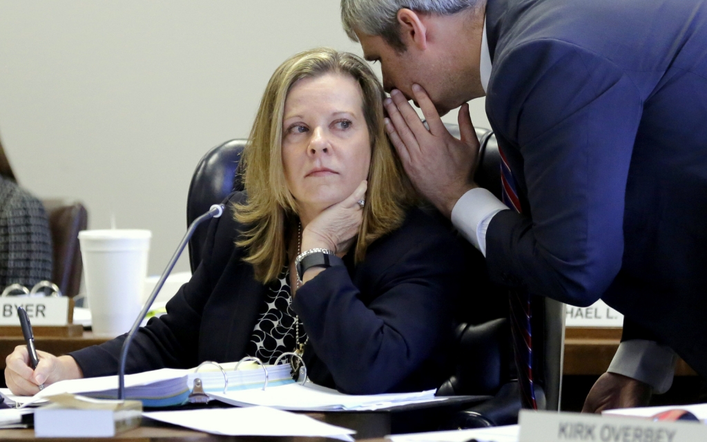 Texas Board of Education Chair Donna Bahorich left listens to Texas Education Agency counsel Von Byer right during a meeing Wednesday Nov. 18 2015 in Austin Texas. Texas could allow university professors to fact-check textbooks approved for state