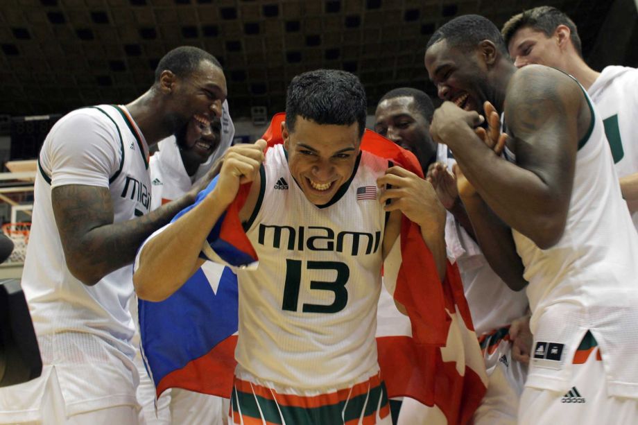 Miami’s Angel Rodriguez center is congratulated by his teammates after being named MVP of the Puerto Rico Tip Off college basketball tournament in San Juan Sunday Nov. 22 2015