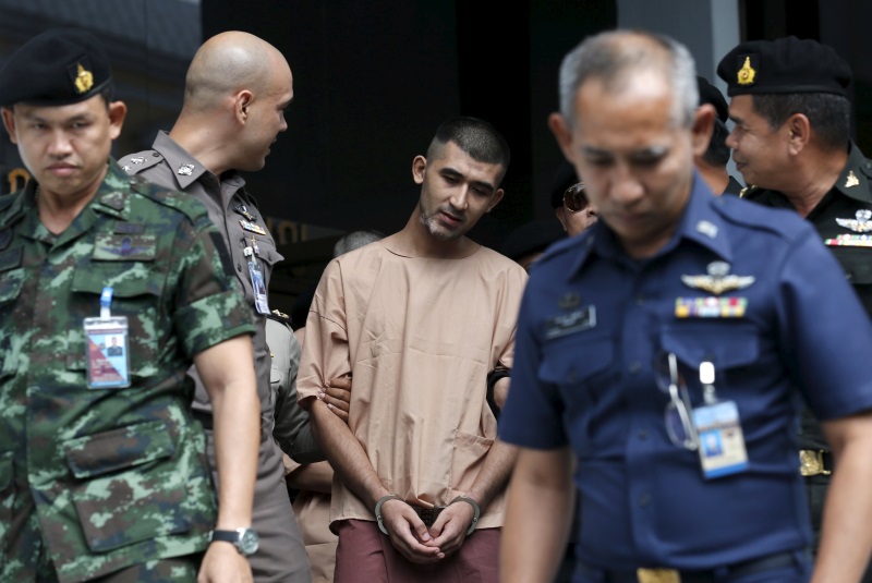 A suspect of the August 17 Bangkok blast who has been referred to as Yusufu Mieraili is escorted by soldiers and prison officers as he leaves the military court in Bangkok Thailand