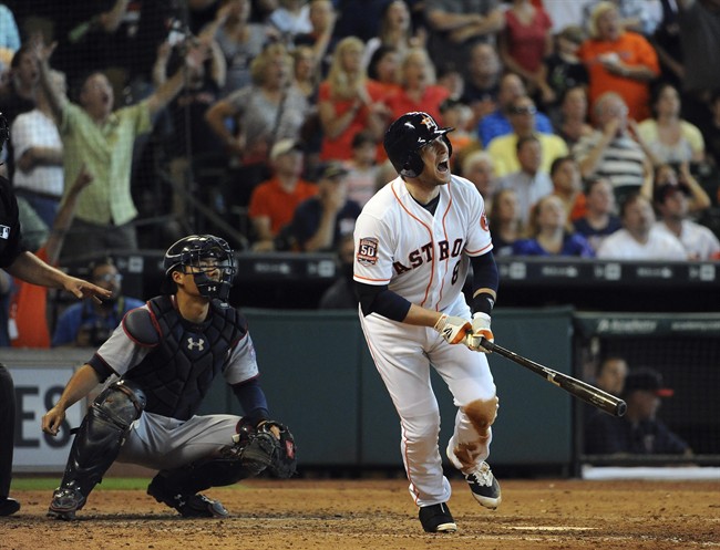 Houston Astros Jed Lowrie watches his grand slam in the seventh inning of a baseball game against the Minnesota Twins in Houston. Infielder Jed Lowrie has been acquired by the Oakland Athletics from the Hous