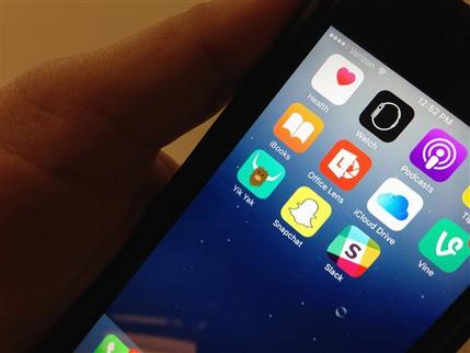 The Yik Yak app lower left is seen on an iPhone