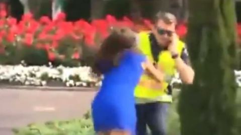 The woman was caught on camera pushing the police officer into the garden