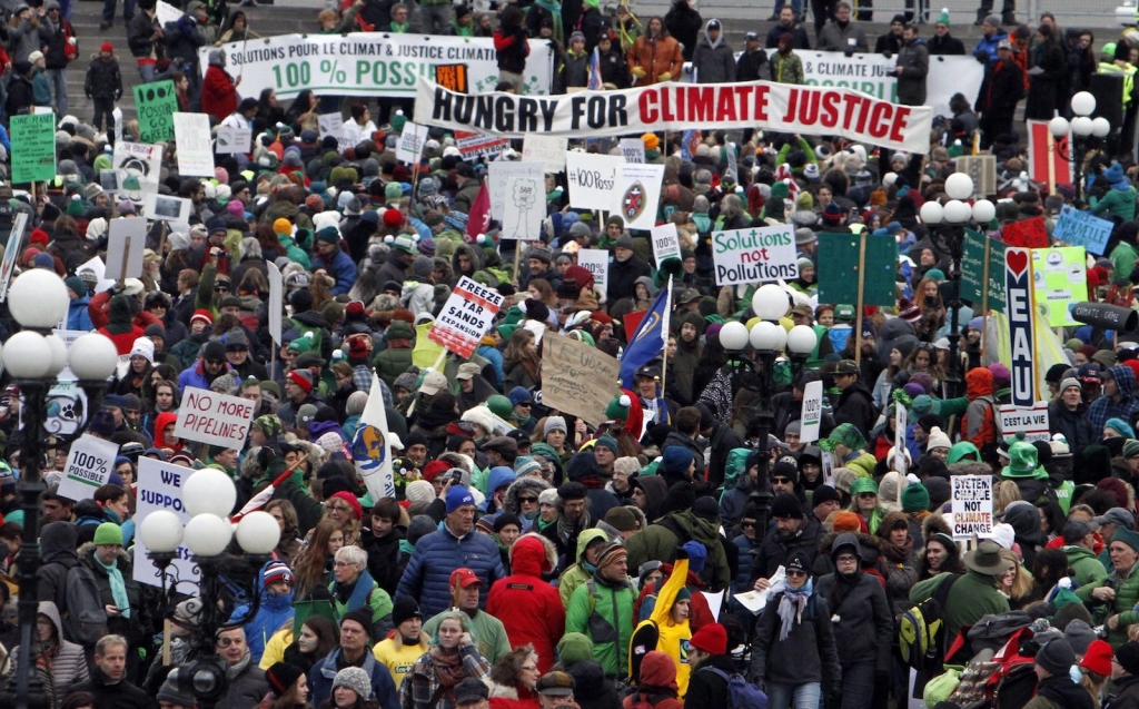 Thousands of people gather for a rally on Parliament Hill on Sunday Nov. 29 2015 in Ottawa against climate change on a day when multiple cities globally saw protests and demonstrations in the lead-up to the United Nations Climate Change Conference