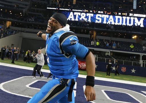 Carolina Panthers quarterback Cam Newton runs through the end zone acknowledging fans after the Panthers 33-14 win over the Dallas Cowboys in an NFL football game Thursday Nov. 26 2015 in Arlington Texas