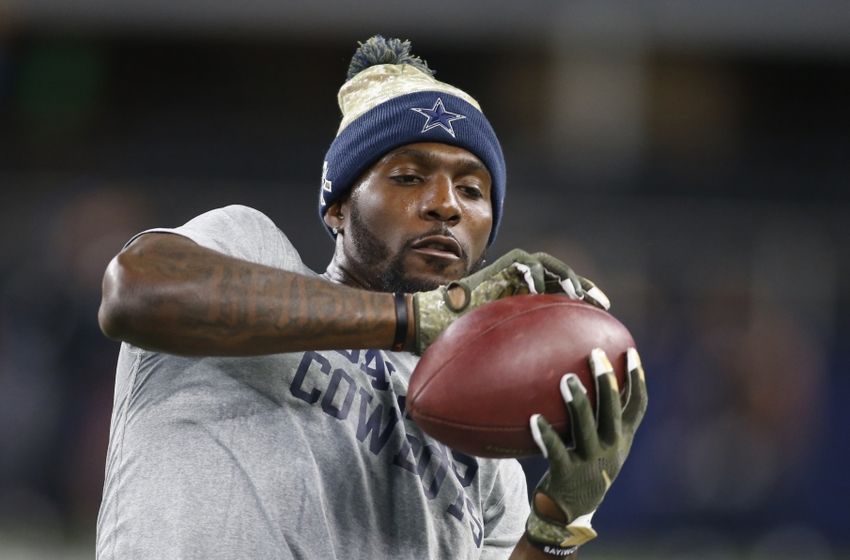 Dez Bryant signs a fan's jersey pregame