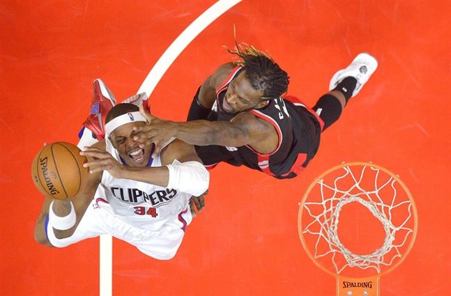 Los Angeles Clippers forward Paul Pierce left shoots as Toronto Raptors forward De Marre Carroll defends during the first half of an NBA basketball game Sunday Nov. 22 2015 in Los Angeles