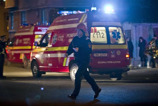 A firefighter runs at the site of a fire that occurred in a club in Bucharest Romania early Saturday Oct. 31 2015. A heavy metal band's pyrotechnical show sparked a deadly fire Friday at a Bucharest nightclub killing more than 20 people and injuring