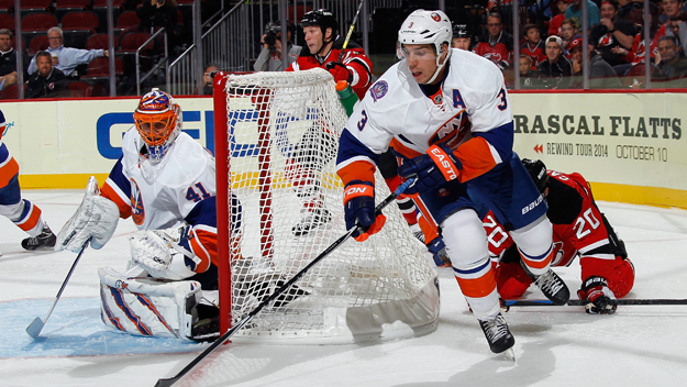 Jaroslav Halak left and Travis Hamonic of the New York Islanders defend against the New Jersey Devils during the second period at the Prudential Center on Oct. 2 2014 in Newark