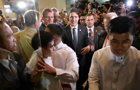 HOT TOPIC Canada’s Prime Minister Justin Trudeau is surrounded by the media and volunteers as he leaves after a news conference at the sidelines of the Asia Pacific Economic Cooperation summit. AFP