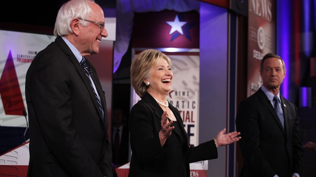 Democratic presidential candidates Bernie Sanders Hillary Clinton and Martin O'Malley stand on the stage prior to Saturday's Democratic primary presidential debate in Des Moines Iowa